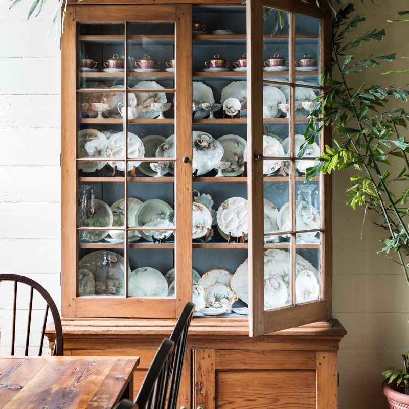 a vase of flowers sitting on top of a wooden table