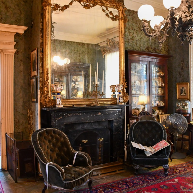 a fire place sitting in a living room filled with furniture and a fireplace