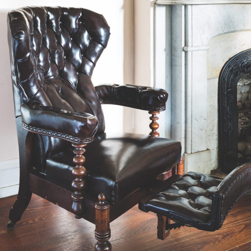 a leather chair sitting in front of a building