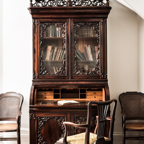 a living room filled with furniture and a fire place sitting in a chair