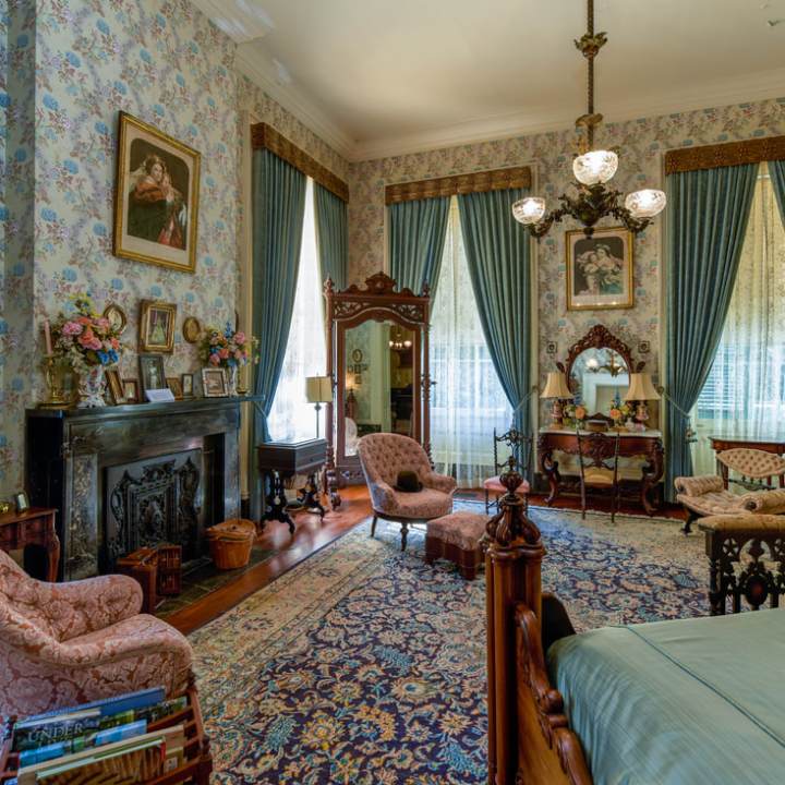 a living room filled with furniture and a fire place sitting in a bedroom