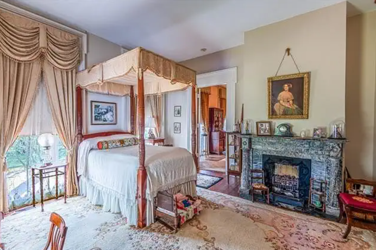 a living room filled with furniture and a bed in a bedroom