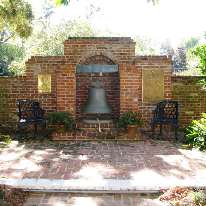 a bench in front of a brick building