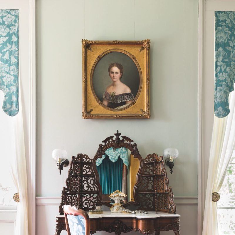 a bedroom with a bed and a mirror