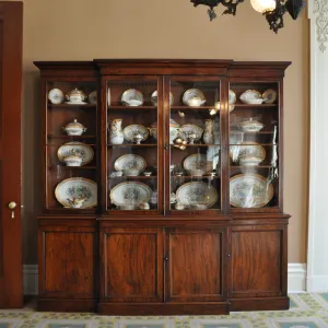a clock on top of a wooden cabinet