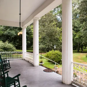 a chair sitting in front of a fence