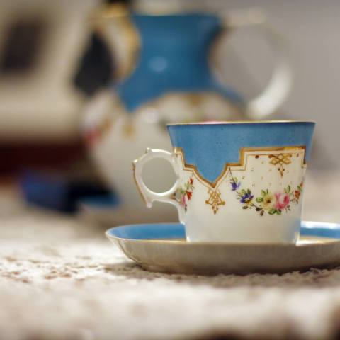 a close up of a blue cup sitting on a table
