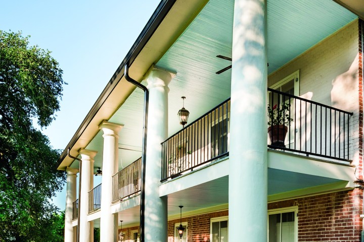 a large brick building with green grass