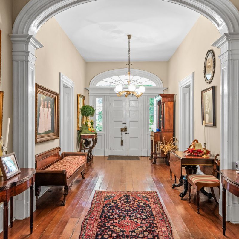 a living room filled with furniture and a large window