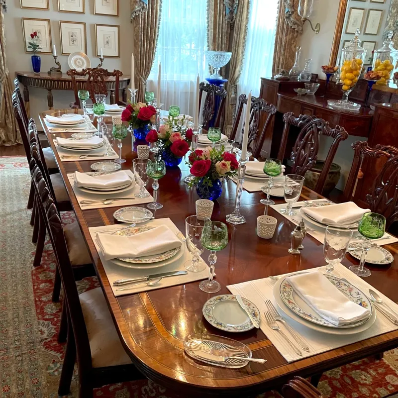 a room filled with furniture and vase of flowers on a table