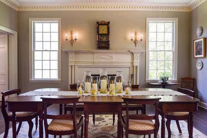 a dining room table in front of a window