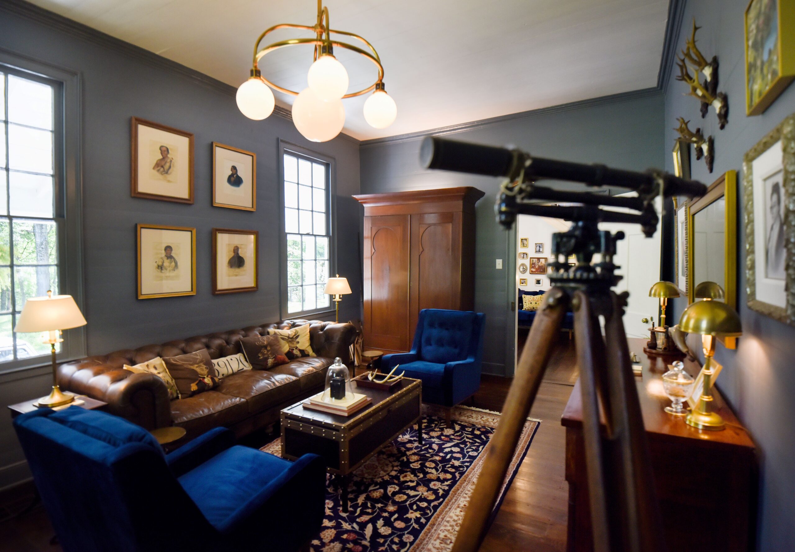 a living room filled with furniture and vase on a table