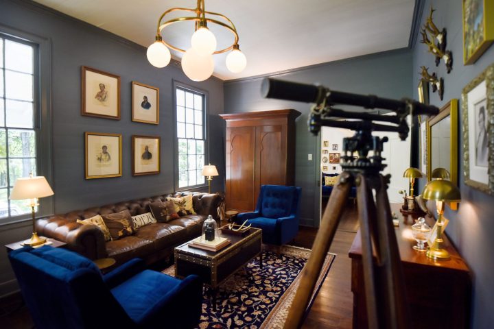 a living room filled with furniture and vase on a table