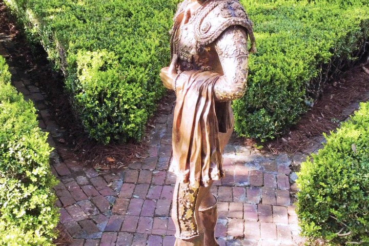 a statue of a person in a garden