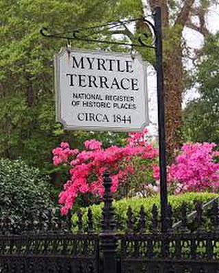 a sign in front of a flower