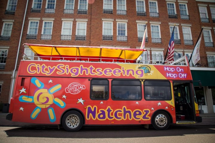 a double decker bus parked on the side of a building