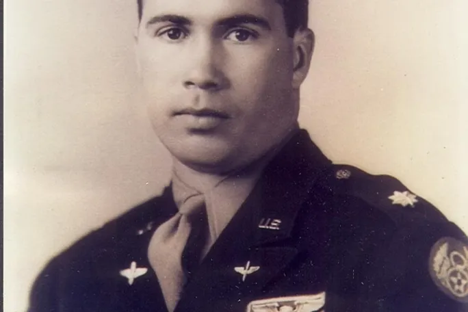 Vintage portrait of a man in military uniform with badges and insignia.